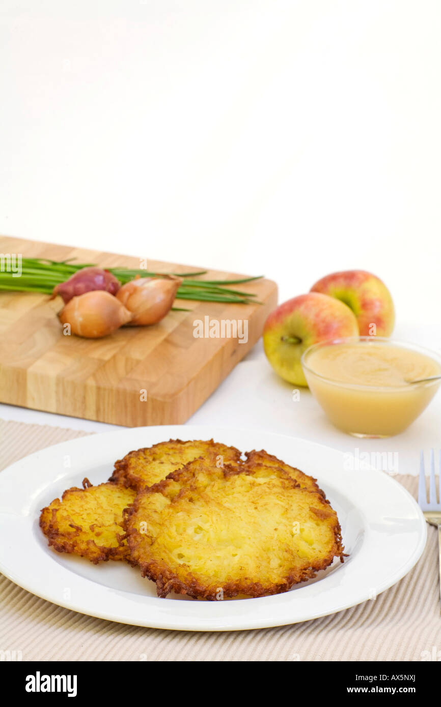 Three potato pancakes with apple sauce Stock Photo