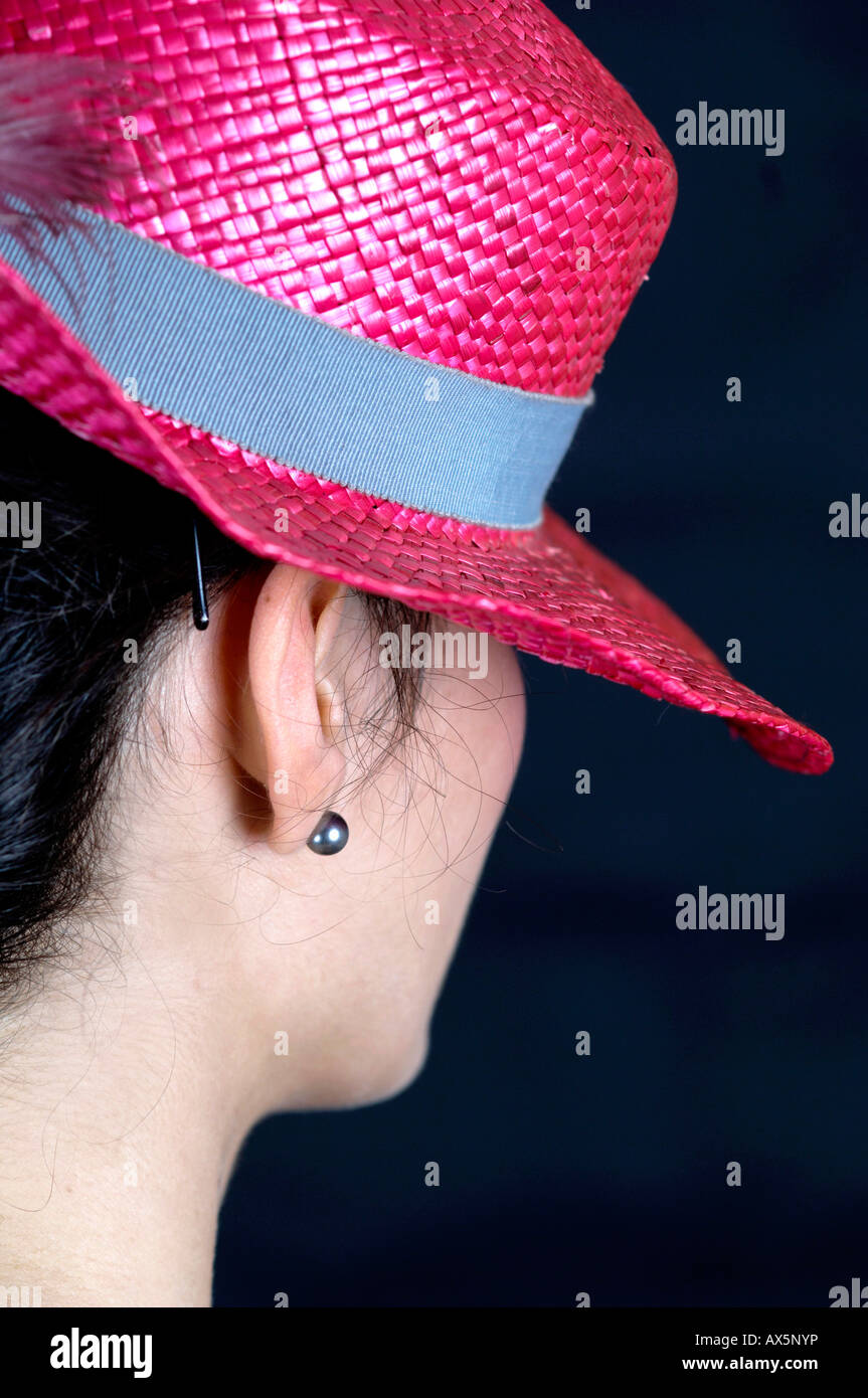 Young woman wearing pink straw hat Stock Photo