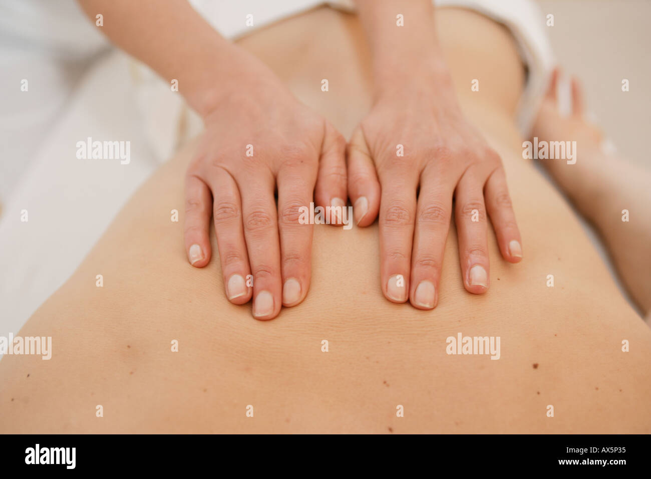A massage therapist massaging a back Stock Photo