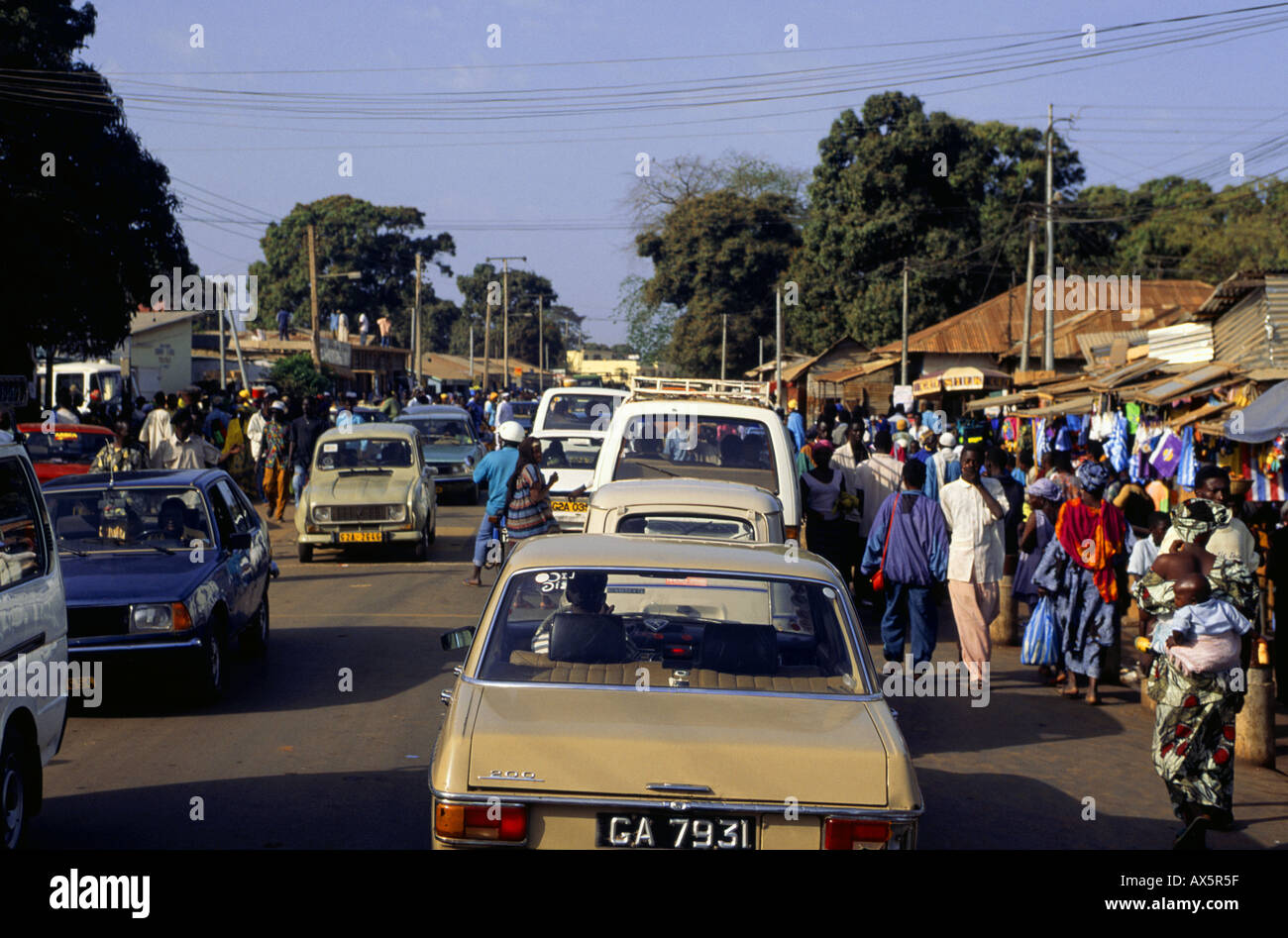 Banjul, Gambia. Busy street with market stalls and traffic Stock Photo