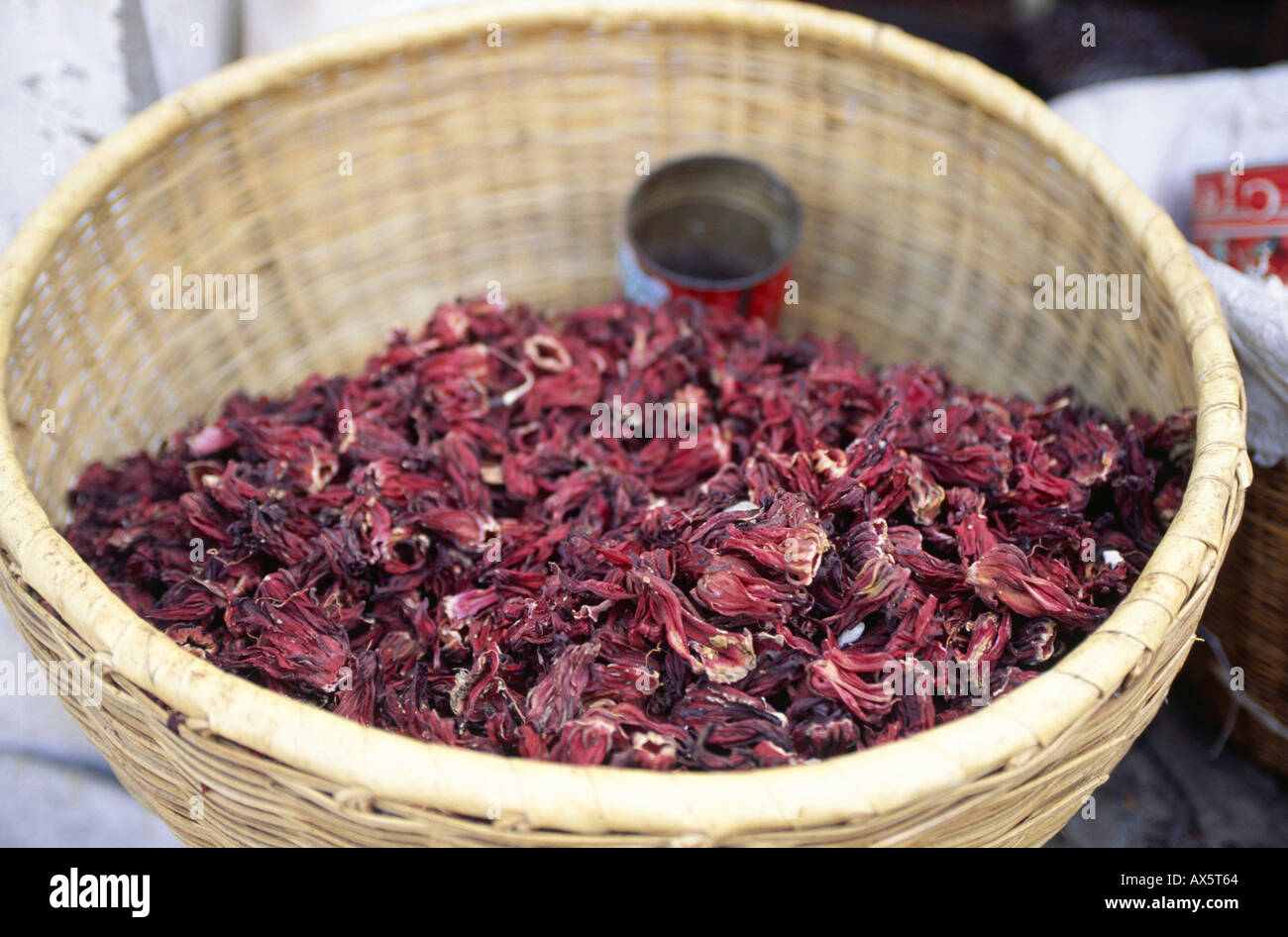 The Gambia. Market place; basket of hibiscus flowers, for hibiscus tea. Stock Photo