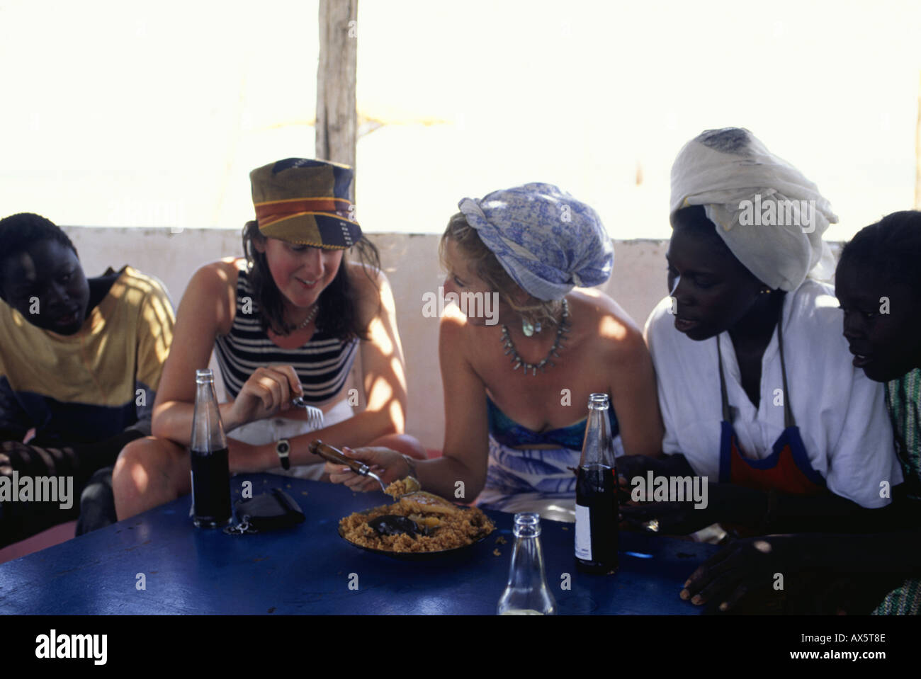 Banjul, Gambia. Tourists trying local food in a small bar restaurant