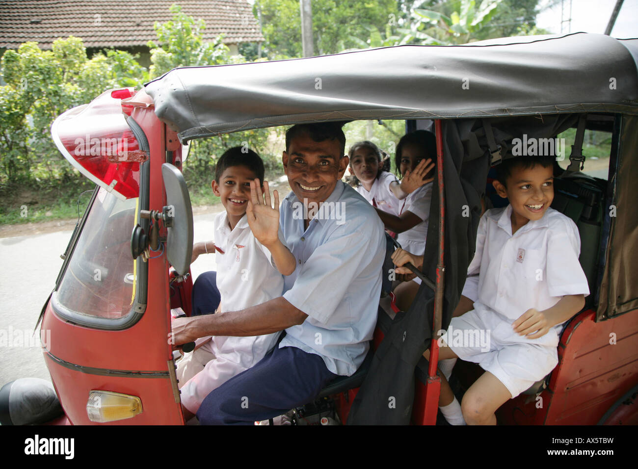 Children dressed in school uniforms, passengers in a tuk-tuk, Godagama, Sri Lanka, Asia Stock Photo