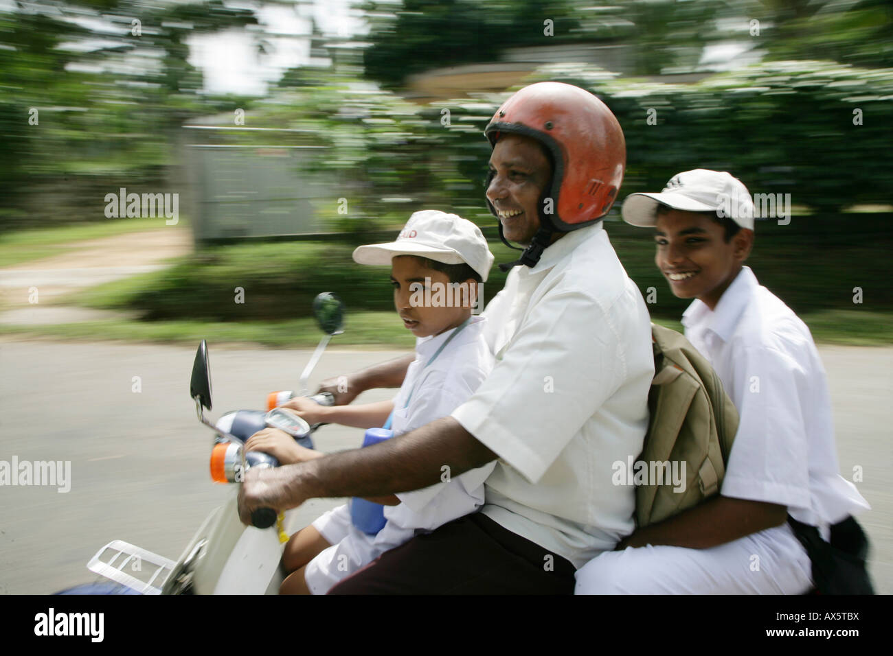 Family piled onto a motorbike in Godagama, Sri Lanka, South Asia Stock Photo