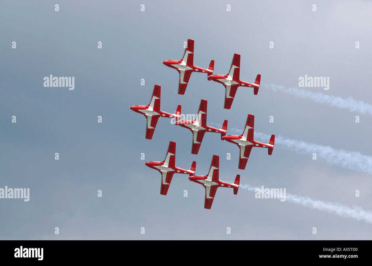 Nine of the red and white Canadian Snowbirds fly in formation leaving ...