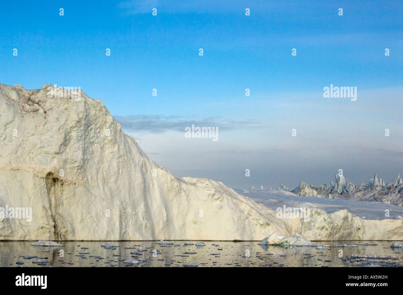 Icebergs photographed circa midnight, Disco Bay near Ilulissat, Western Greenland Stock Photo
