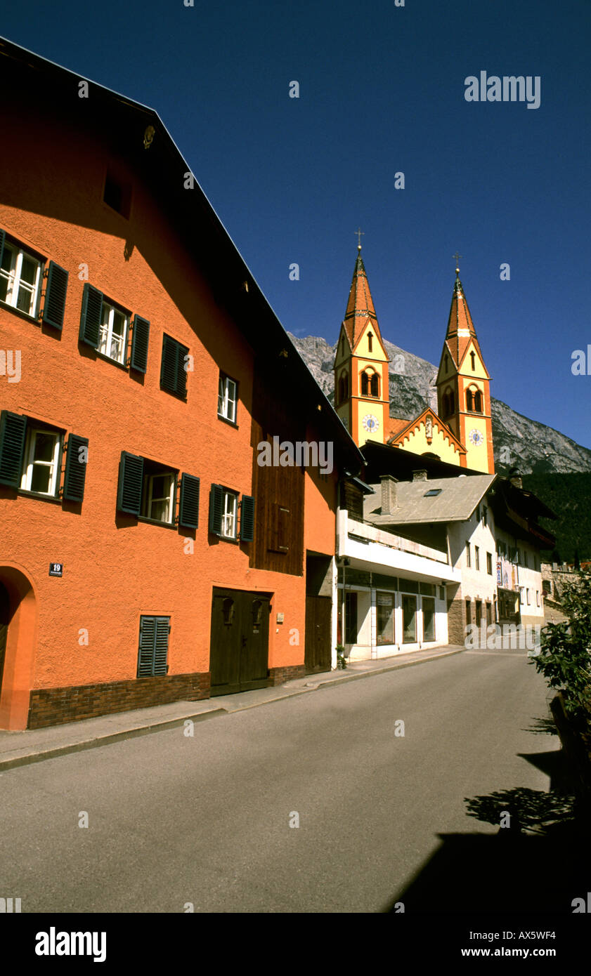 Street leading to Peter and Paul Catholic Church color in Telfs Austria near Innsbruck Stock Photo