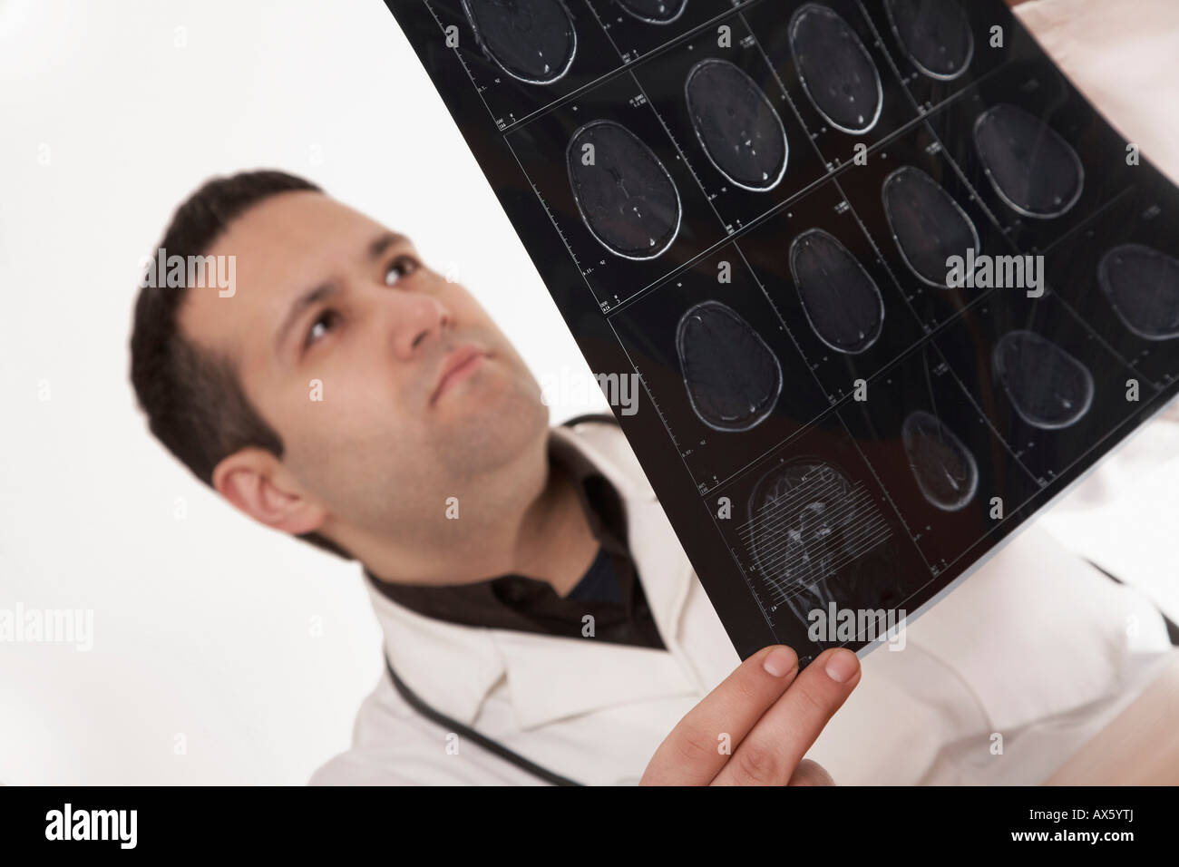 Physician with stethoscope examining X-ray image Stock Photo