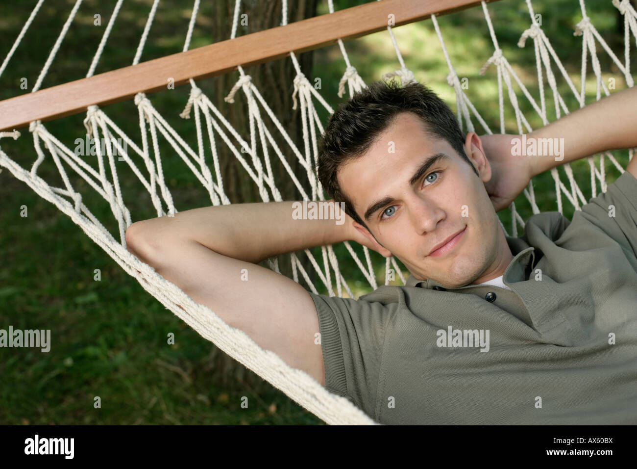Mid adult man lying in hammock hi-res stock photography and images - Alamy
