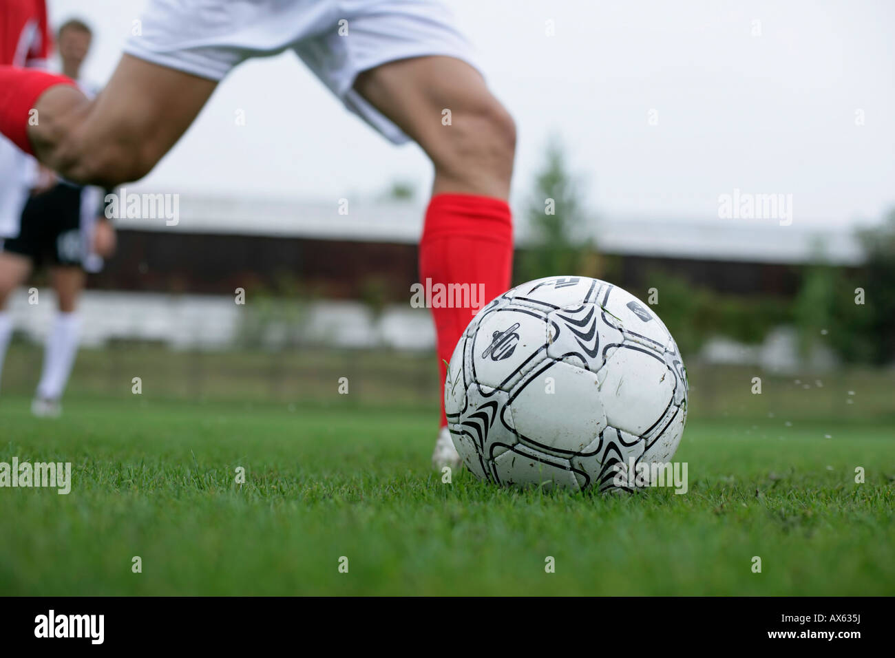 Soccer player kicking a football Stock Photo Alamy