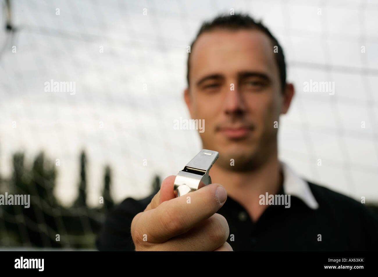 Referee holding a whistle Stock Photo Alamy