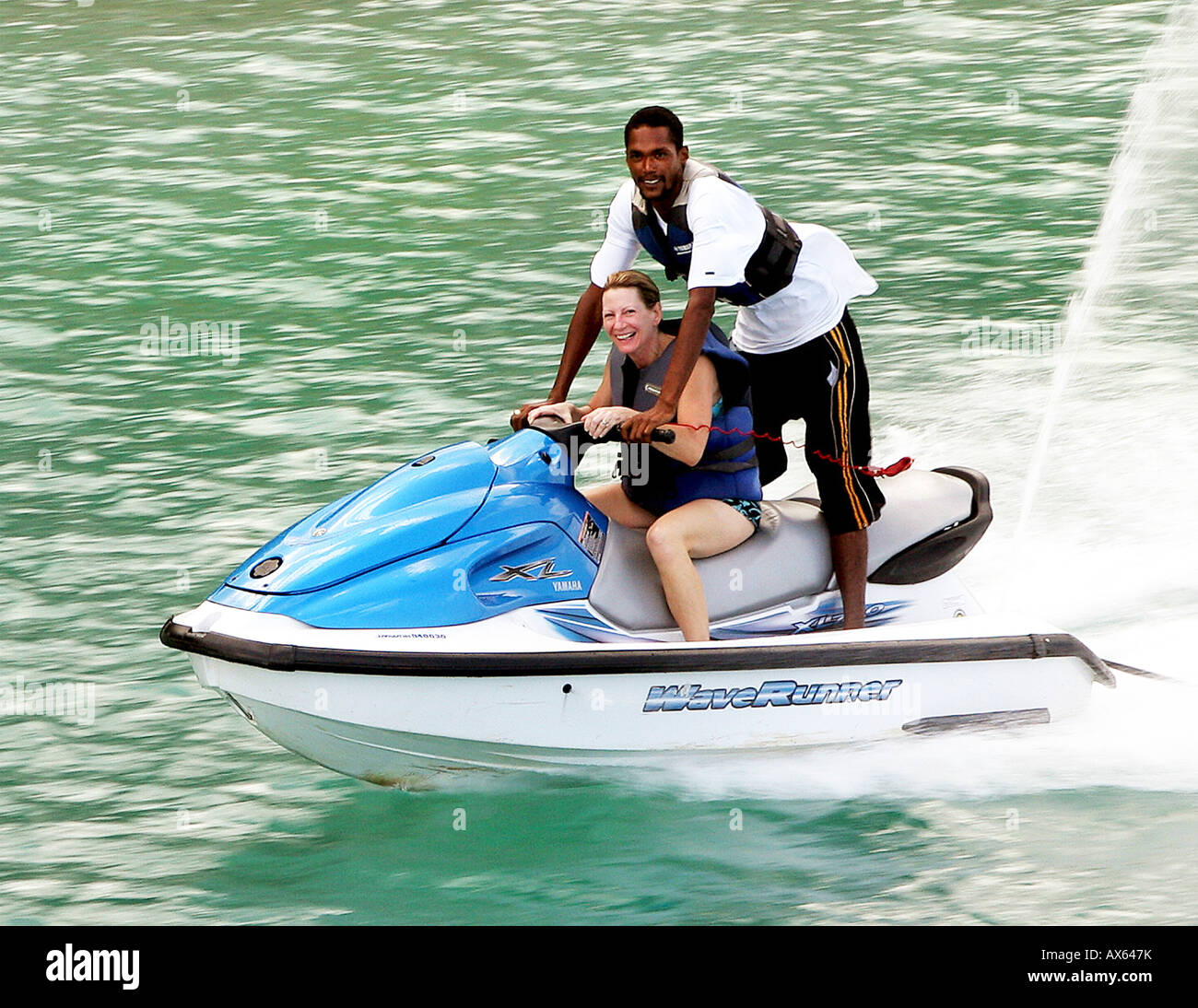 Tourist rides jet ski with local Ocho Rios Jamaica Woman is Model