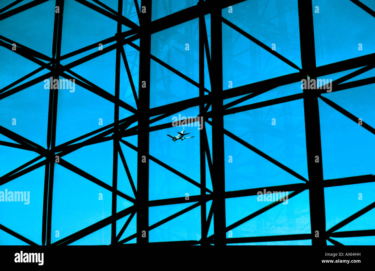 Passenger jet seen through glass atrium of Kennedy Library in Boston USA Stock Photo