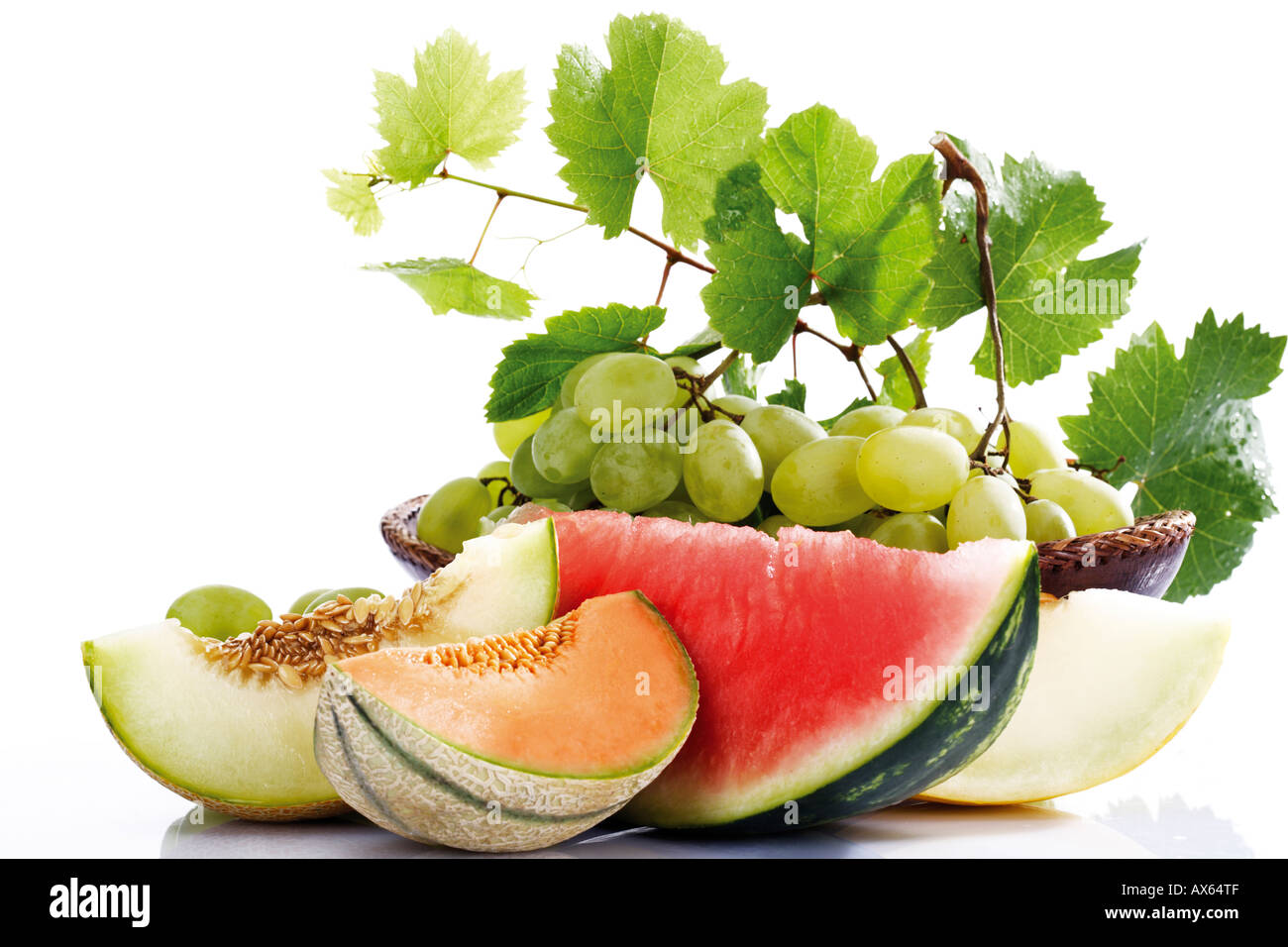 Various sliced melons and grapes, close-up Stock Photo