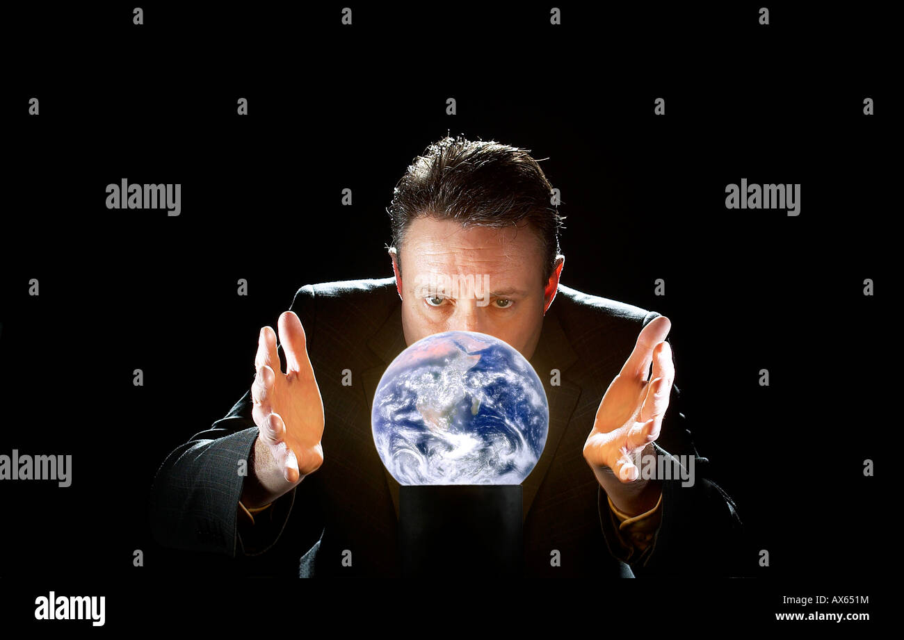 BUSINESSMAN SEES THE FUTURE OF PLANET EARTH IN A CRYSTAL BALL Stock ...