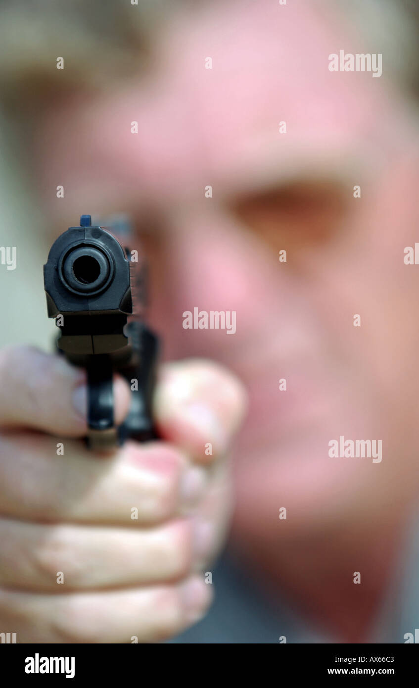 Man pointing a BB handgun Stock Photo