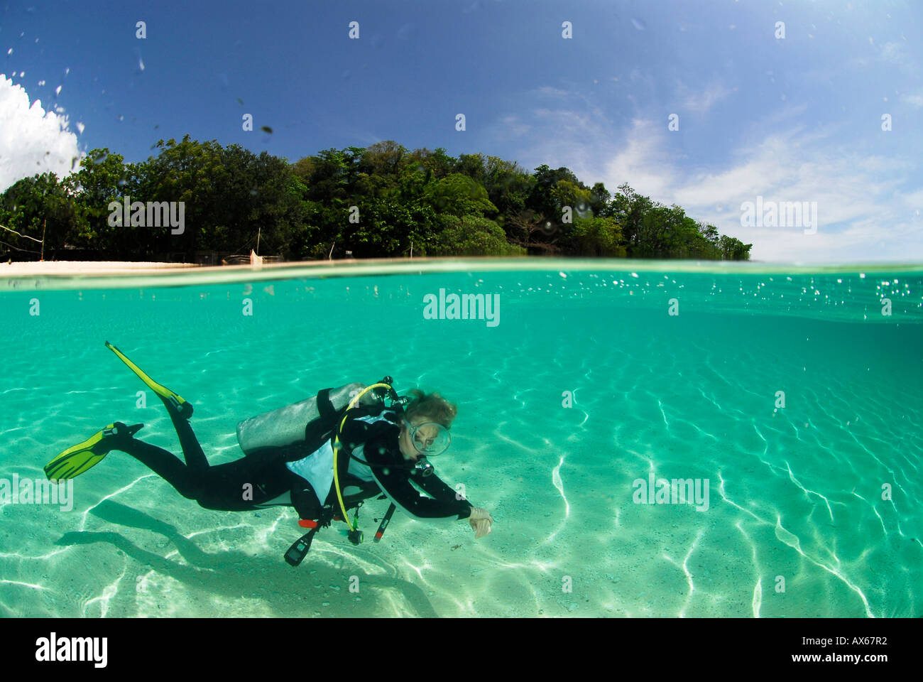 Philippines, Dalmakya Island, woman scuba diver in sea, underwater view