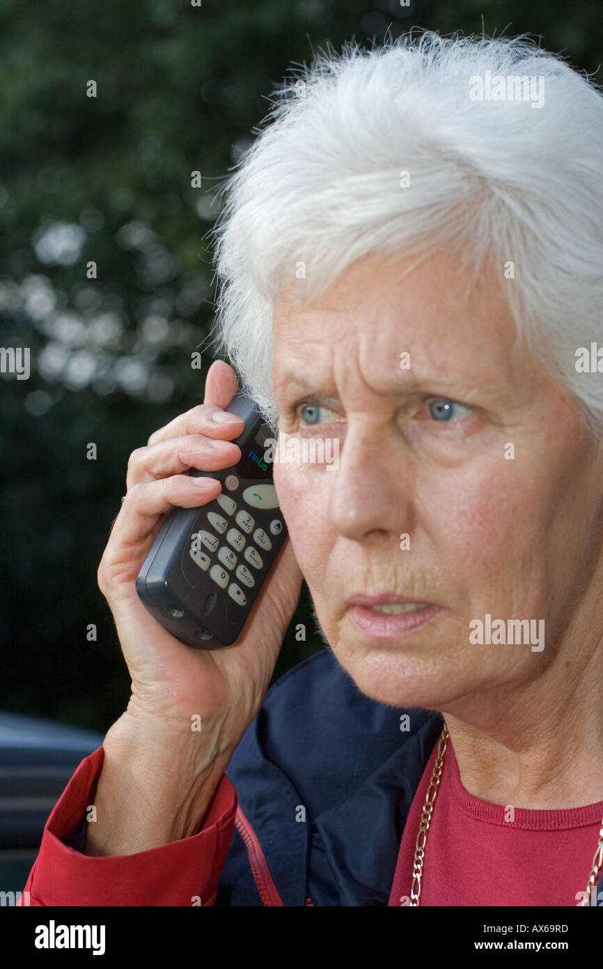 Close up of woman speaking on old Nokia mobile phone UK Stock Photo