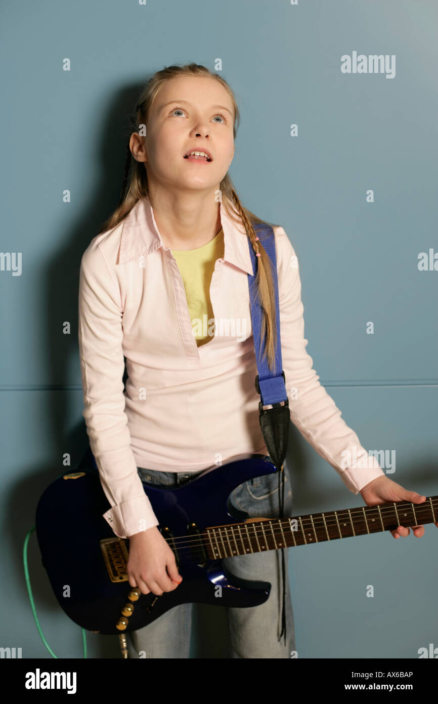 Girl holding an electric guitar Stock Photo - Alamy