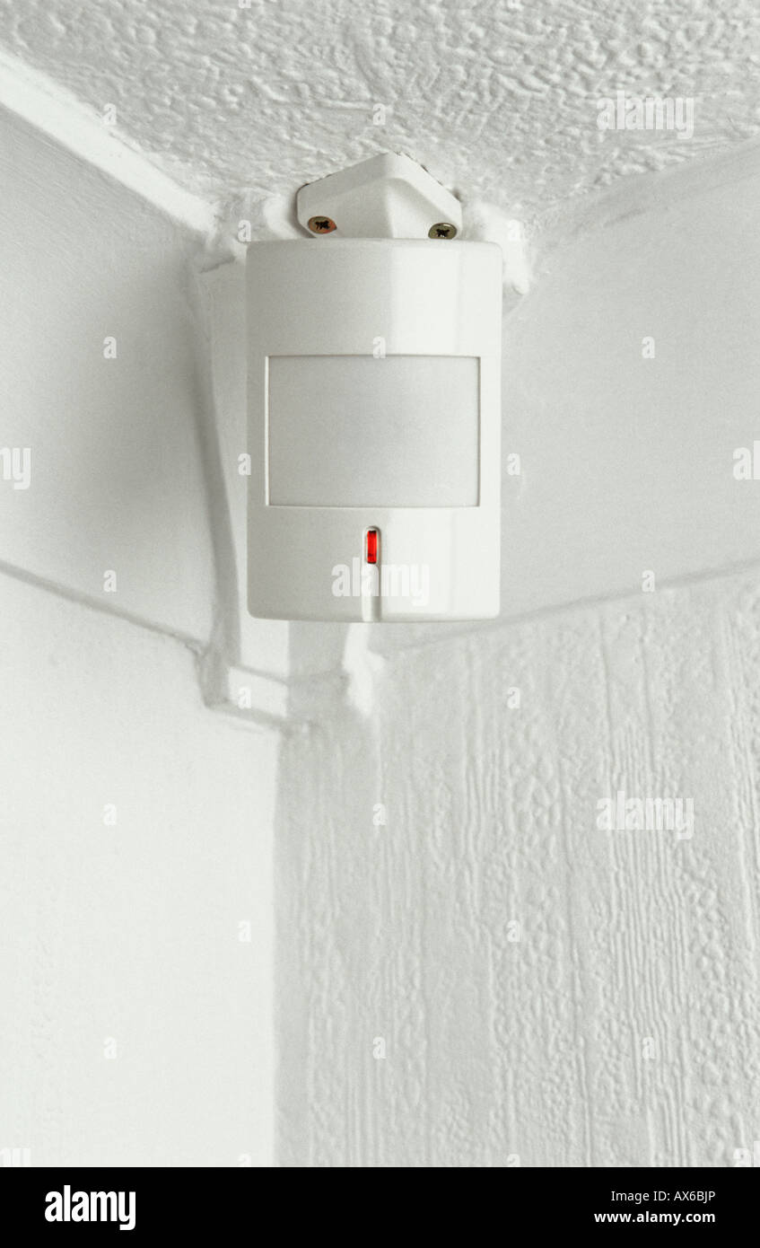 PIR motion security sensor mounted onto white ceiling Stock Photo - Alamy