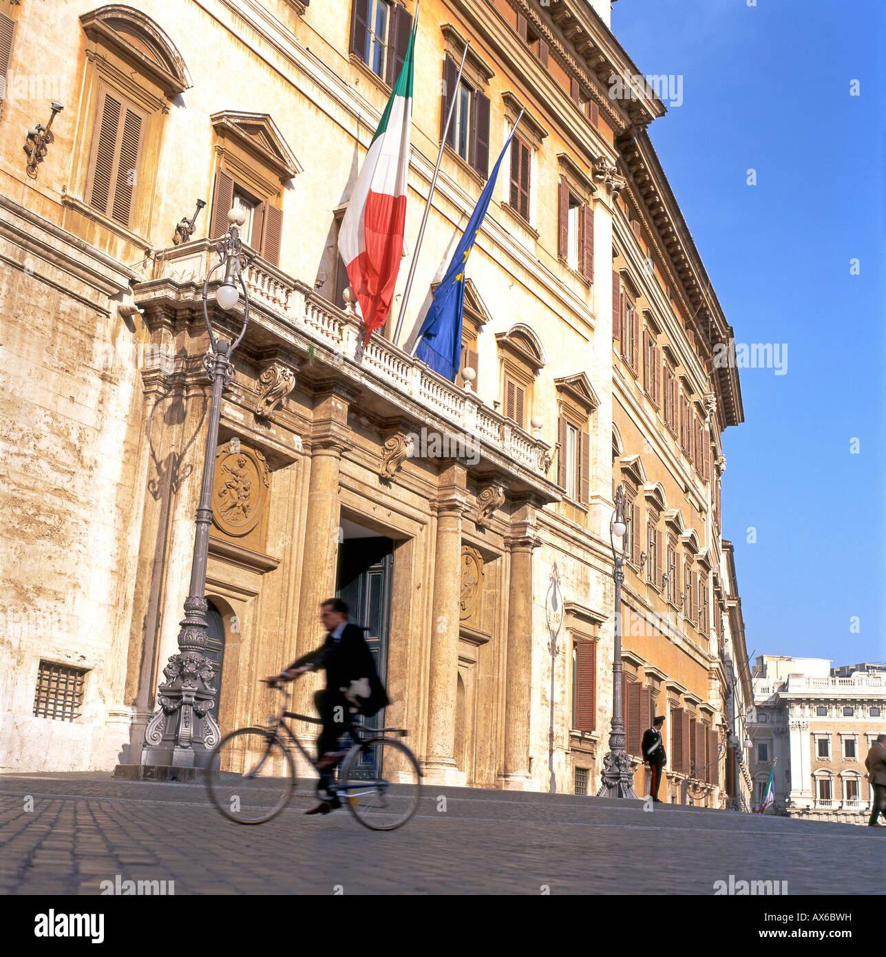 A man cycling past the Italian Parliament building Palazzo di Montecitorio,  in Rome, Italy KATHY DEWITT Stock Photo