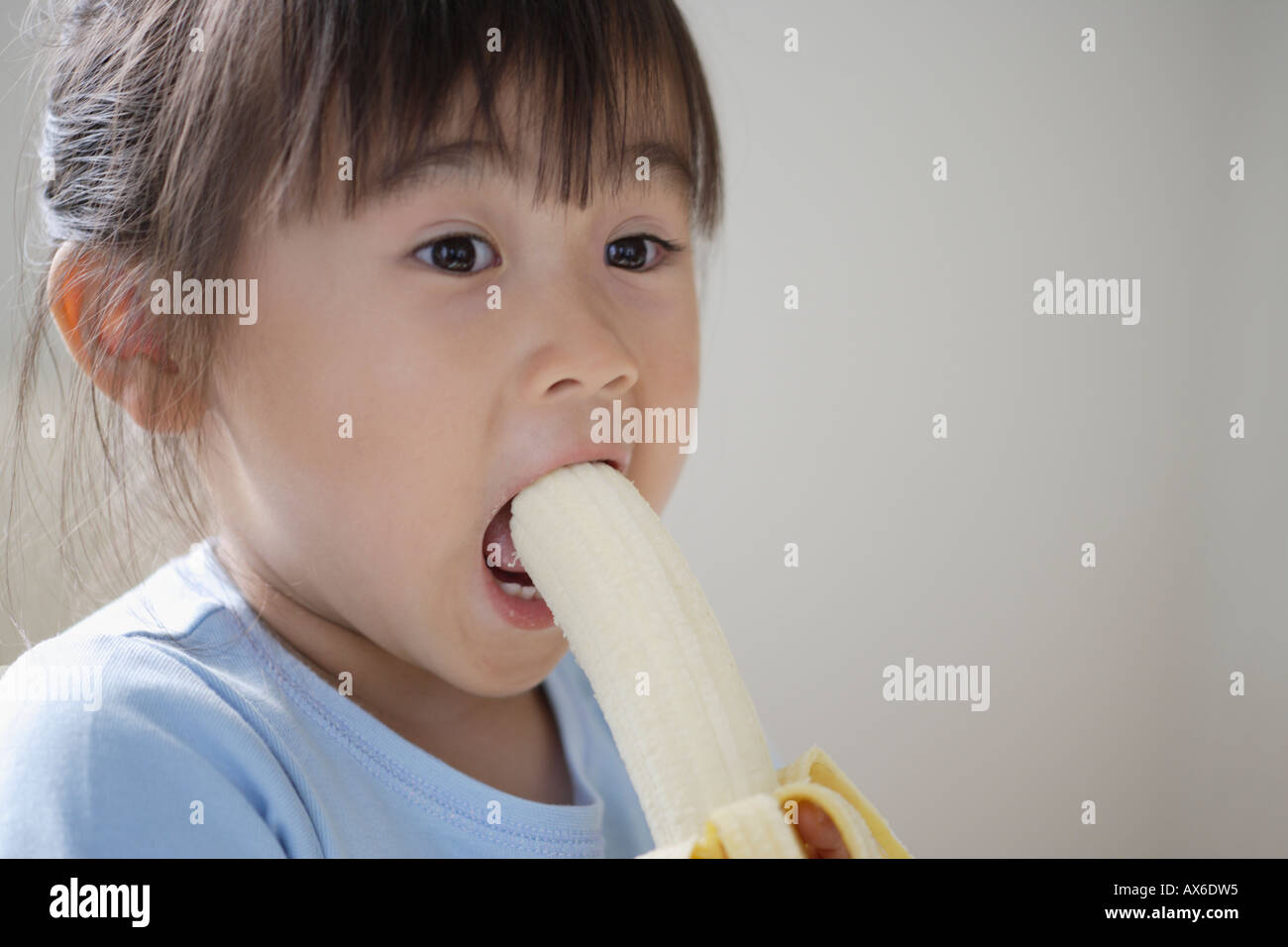 A girl eating banana Stock Photo Alamy