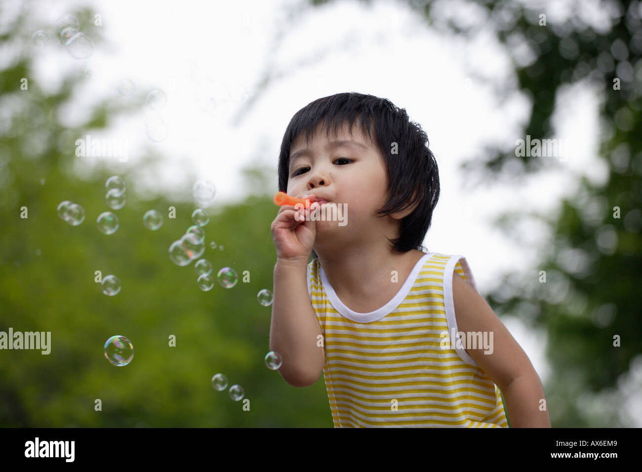 A boy blowing bubbles Stock Photo