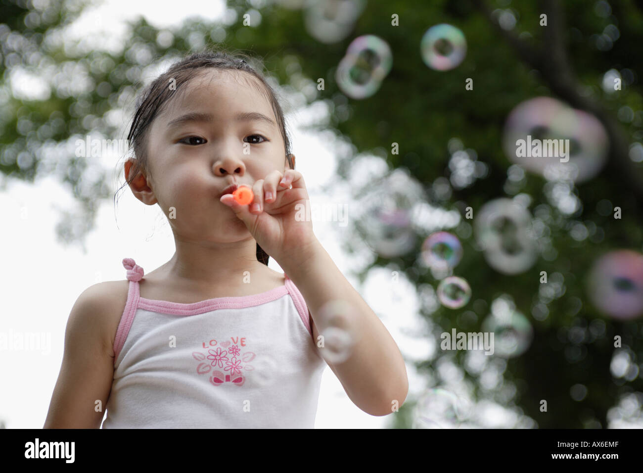 A girl blowing bubbles Stock Photo Alamy