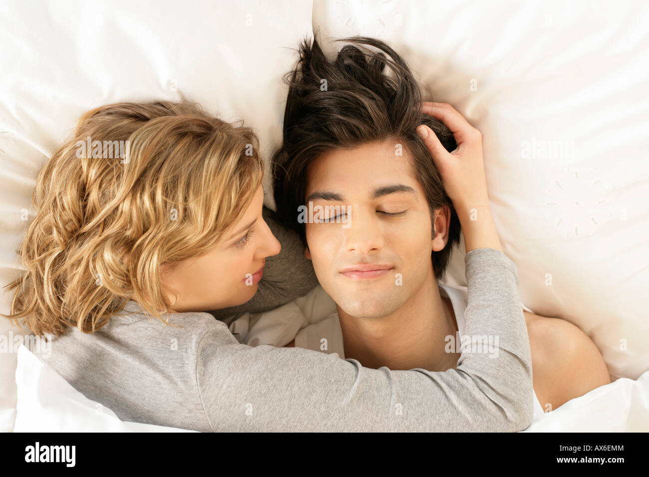 Woman touching man's hair hi-res stock photography and images - Alamy