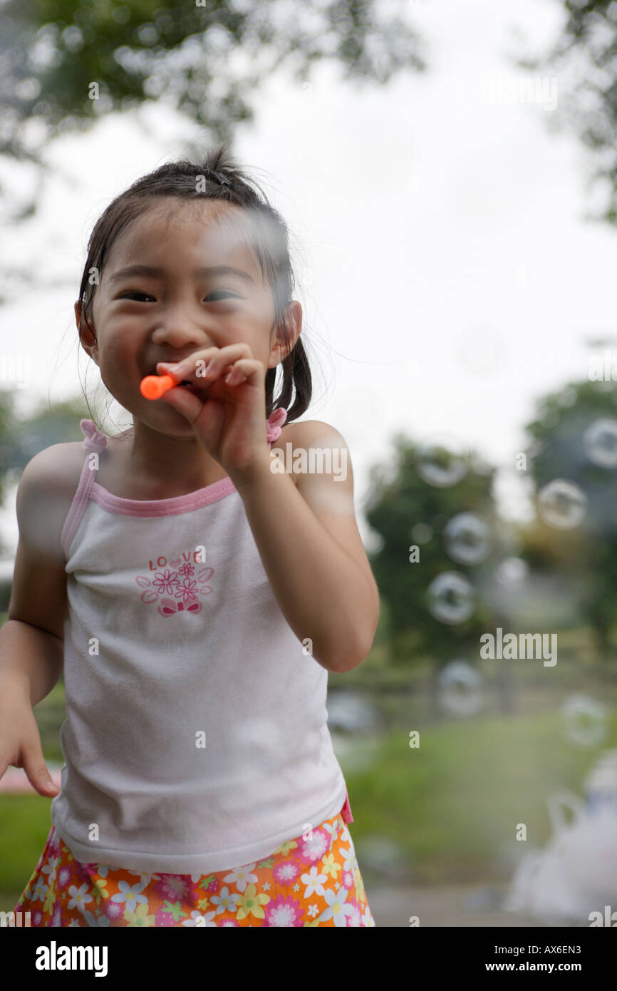 Laughing girl blowing bubbles hi-res stock photography and images - Alamy