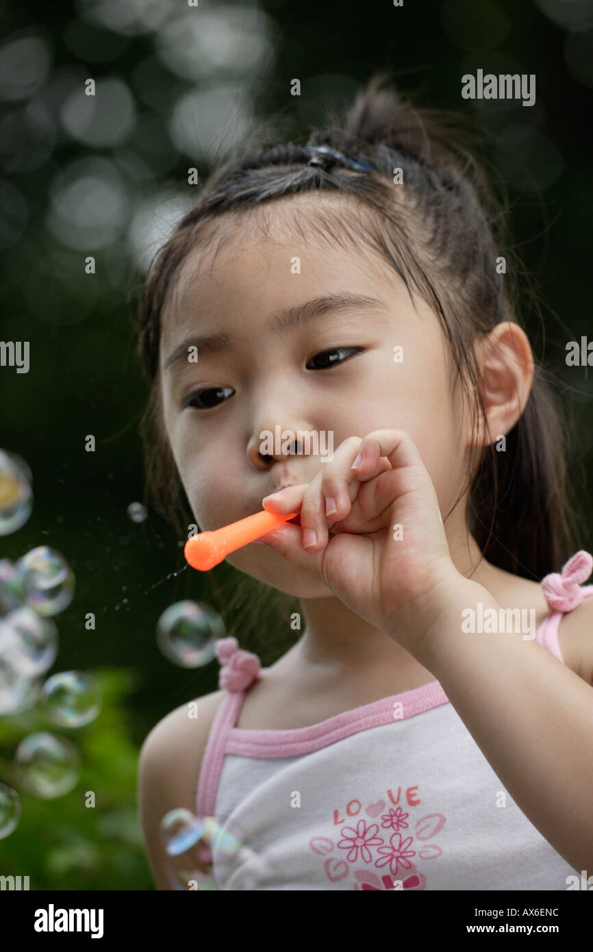 A girl blowing bubbles Stock Photo Alamy