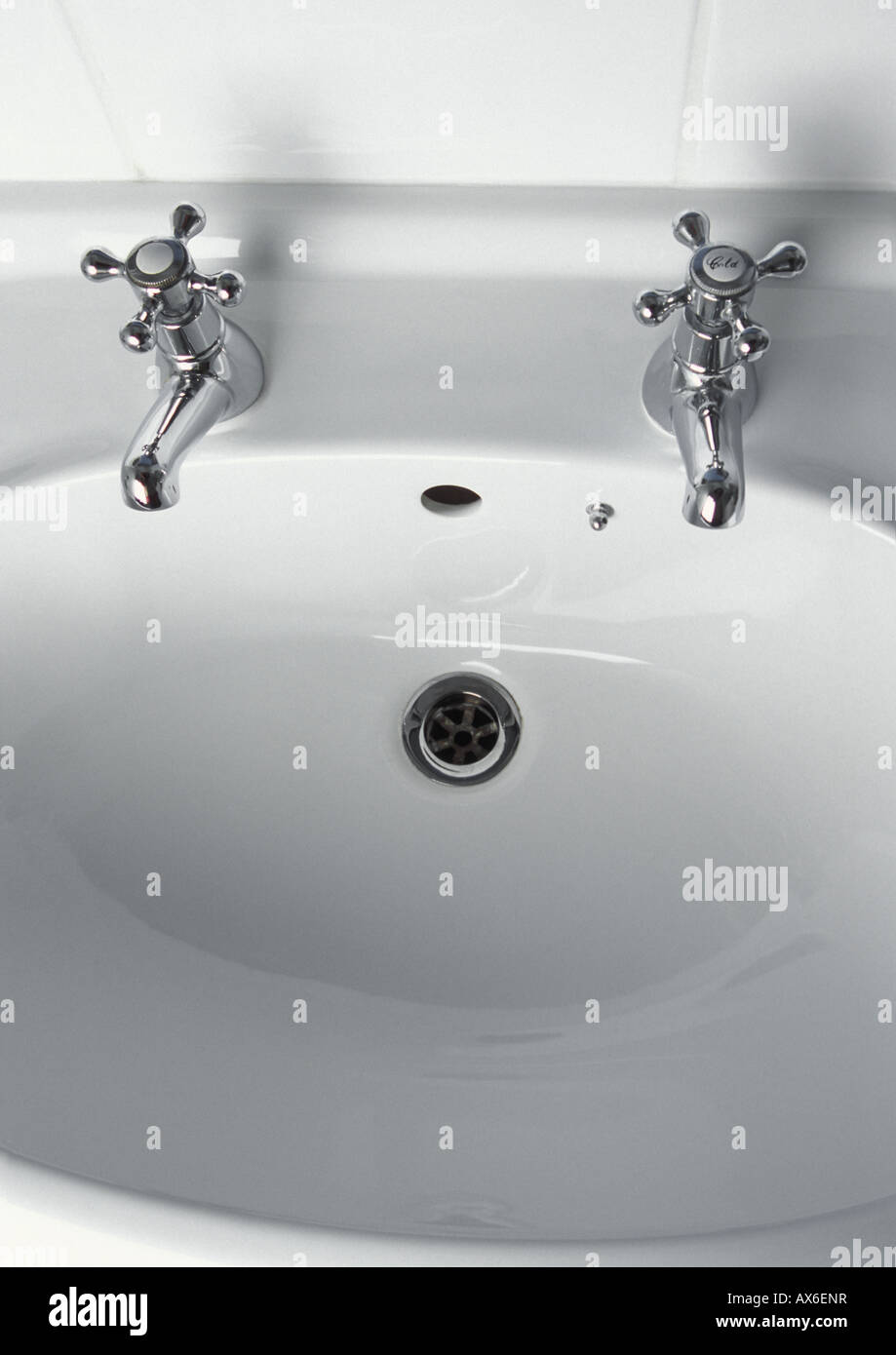 Traditional chrome taps on white bathroom sink basin Stock Photo Alamy