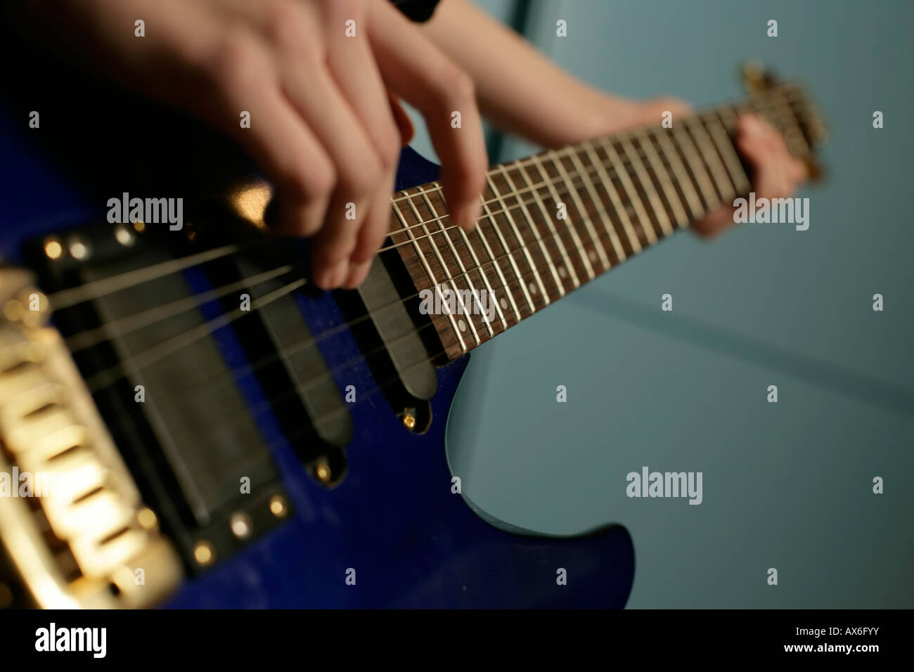 Girl playing an electric guitar Stock Photo - Alamy