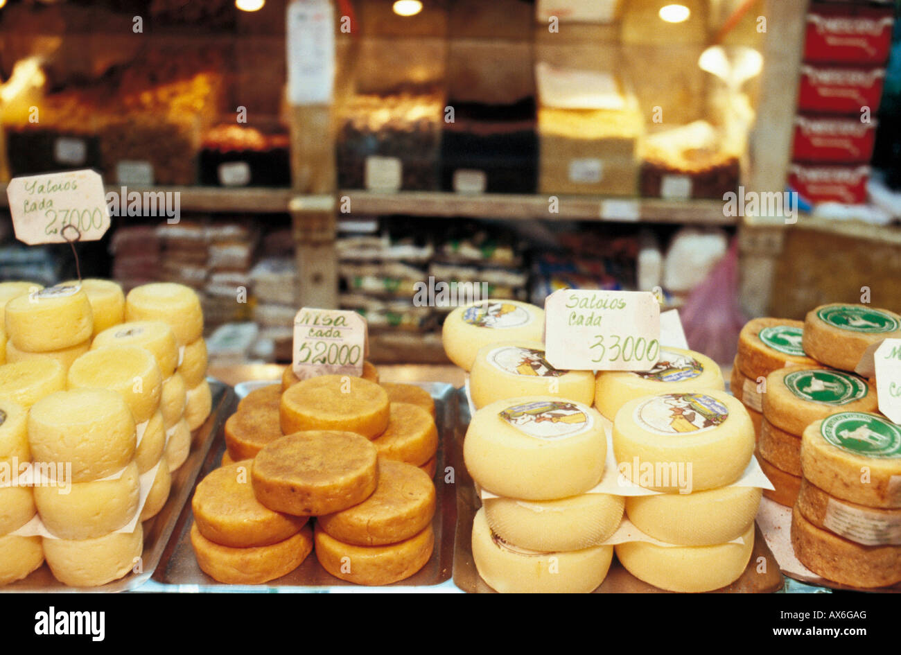 Stack of cheese wheels on sale in market, Baixa, Lisbon, Portugal, Europe Stock Photo