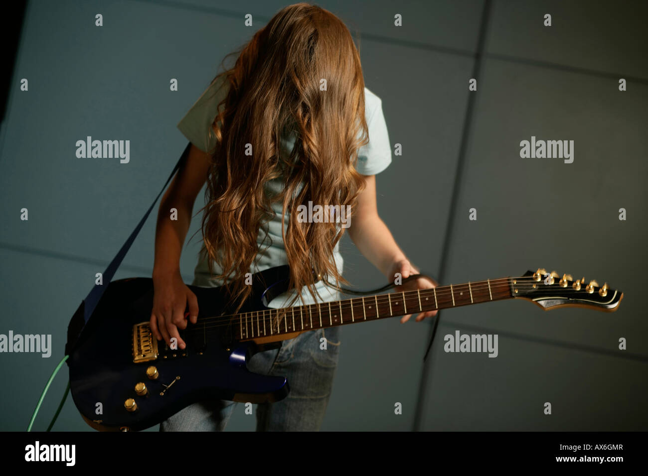 Girl playing an electric guitar Stock Photo - Alamy