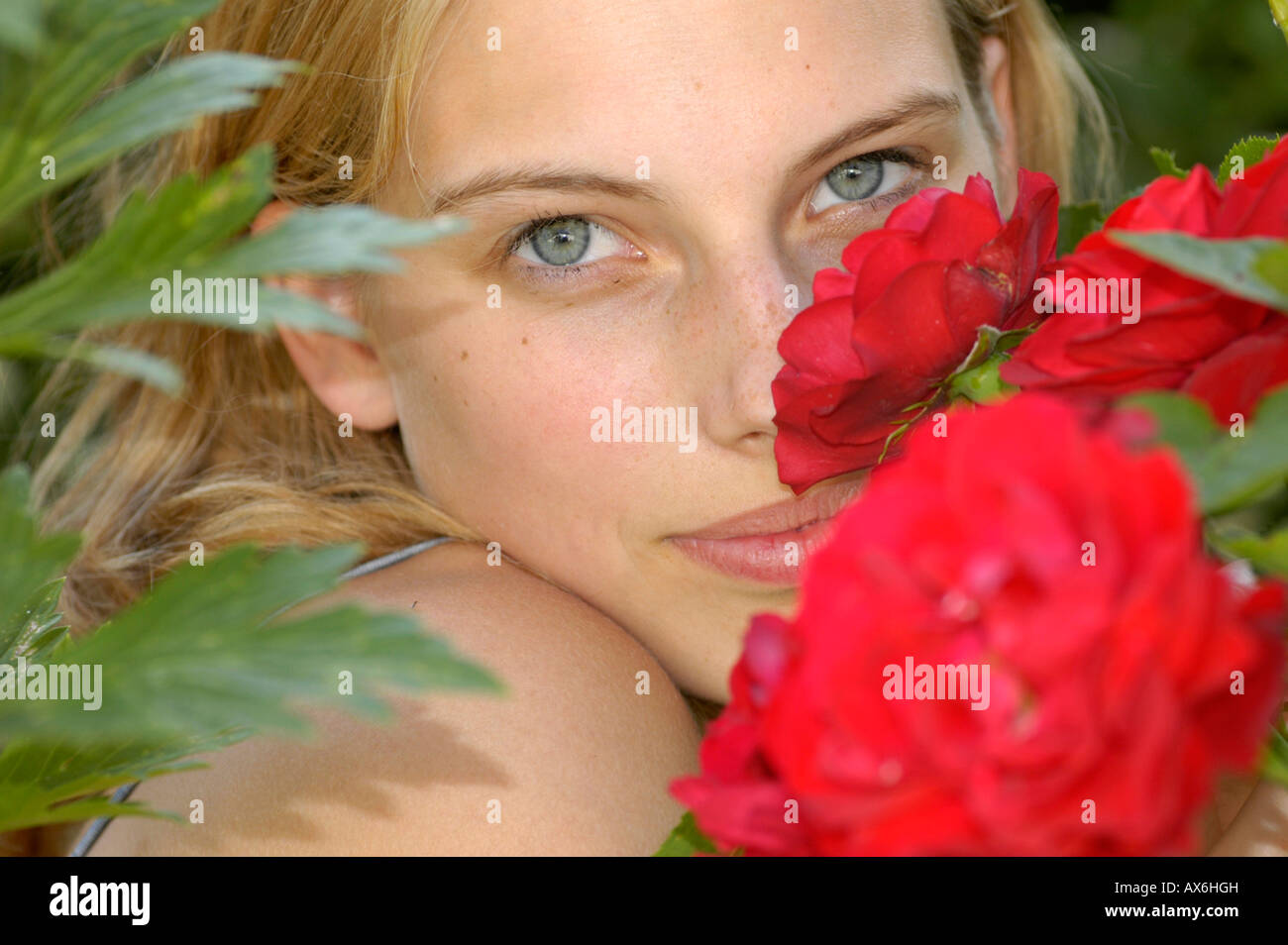 Portrait of young woman smelling flower Stock Photo Alamy