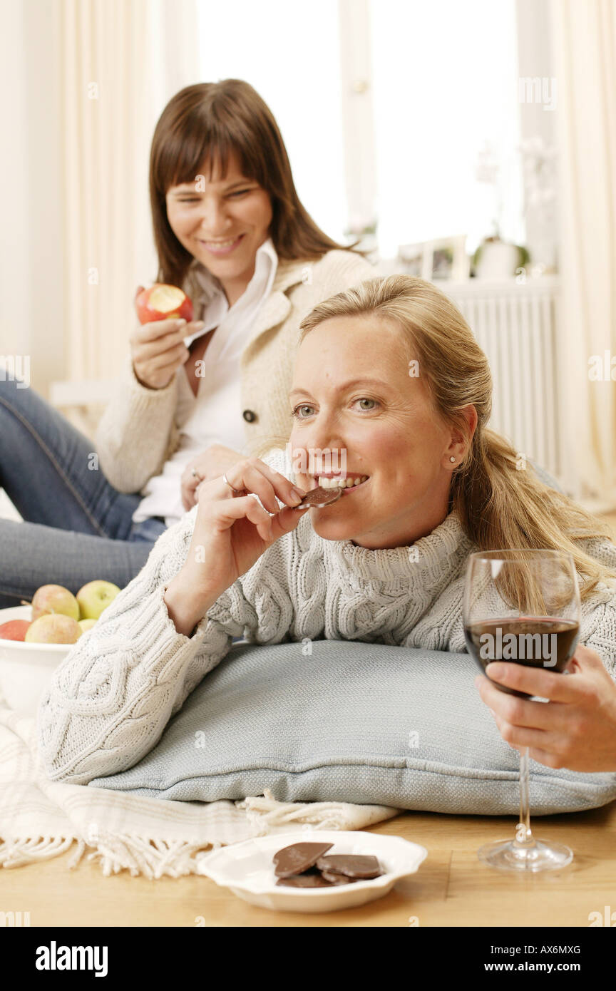 Woman looking at her mother eating chocolate Stock Photo Alamy