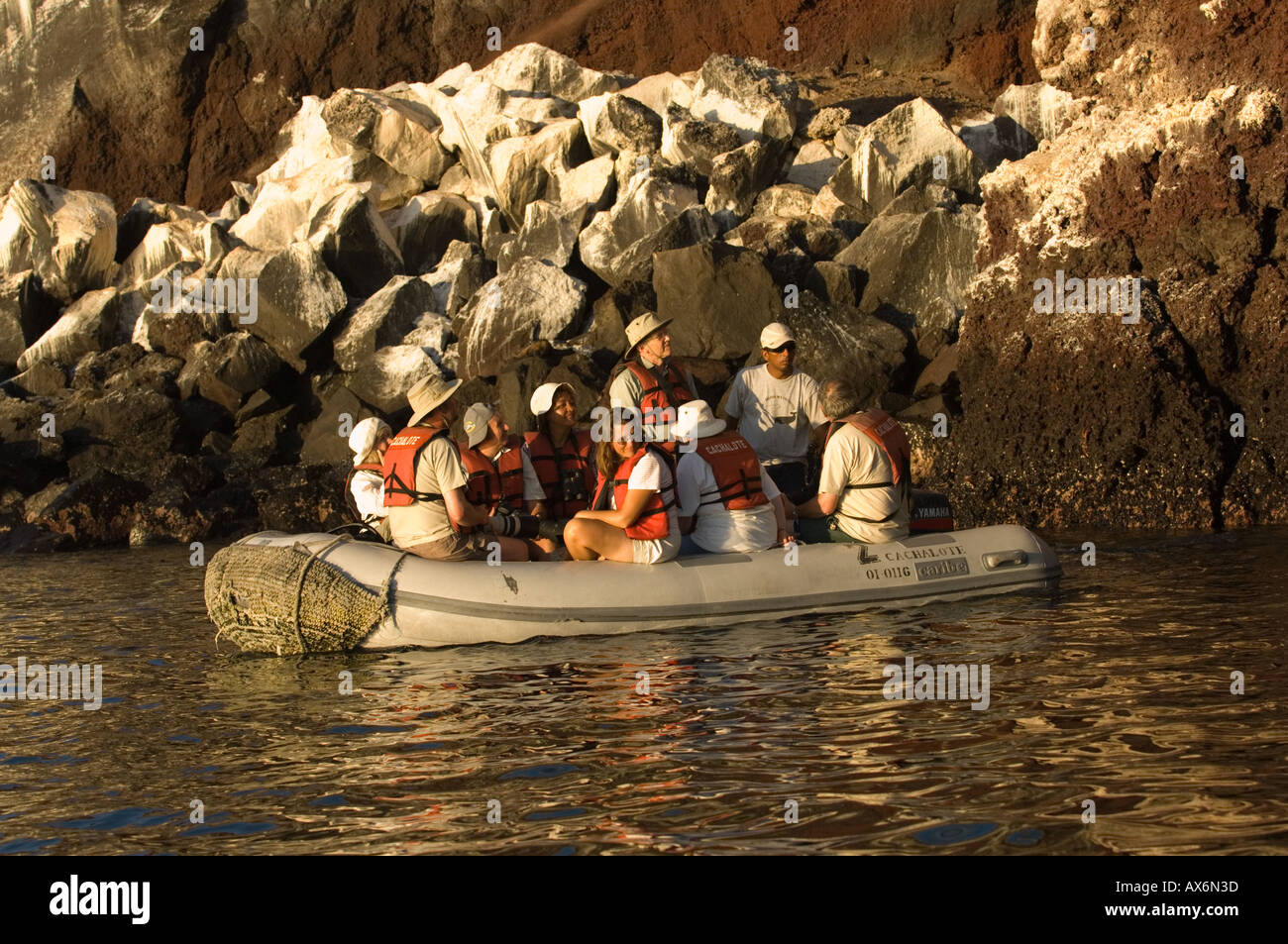 Touirst exploring coastline off Punta Moreno Isabela Island Galapagos