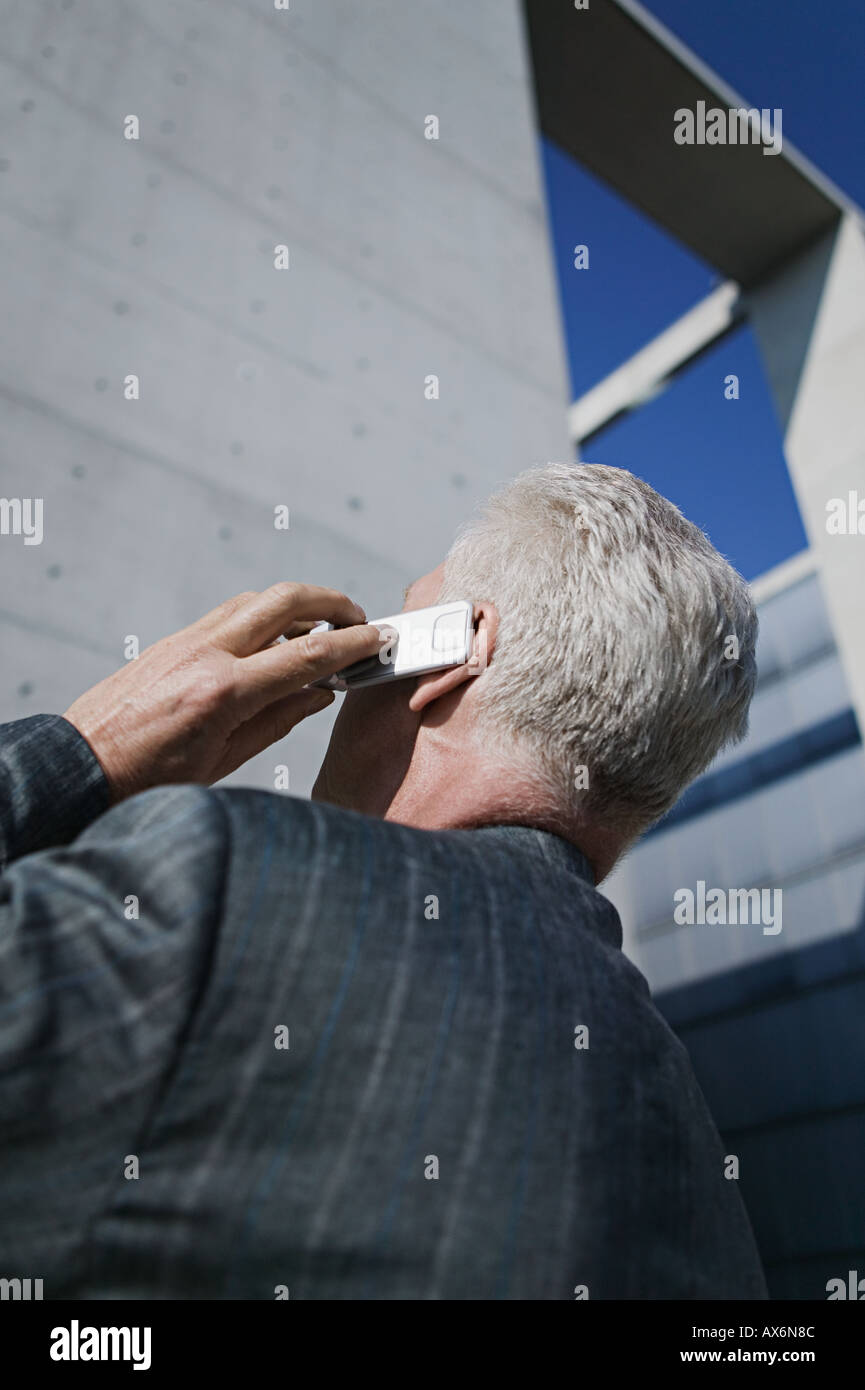 Mature businessman using mobile phone Stock Photo