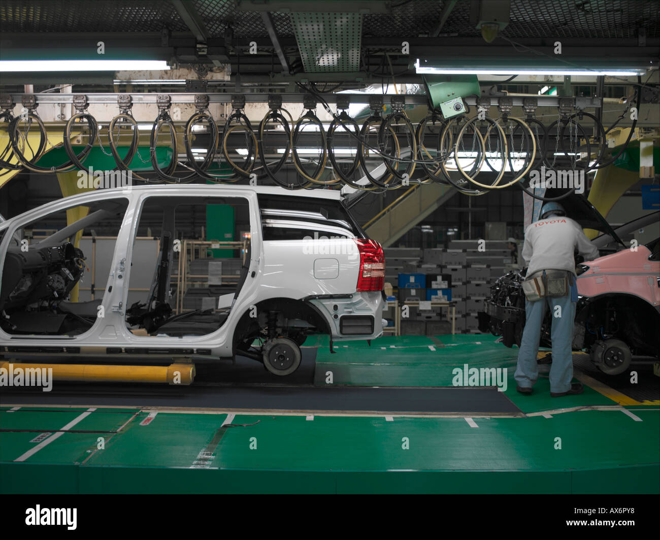Factory workers producing the hybrid Toyota Prius cars work on the assembly line at the Toyota City Stock Photo
