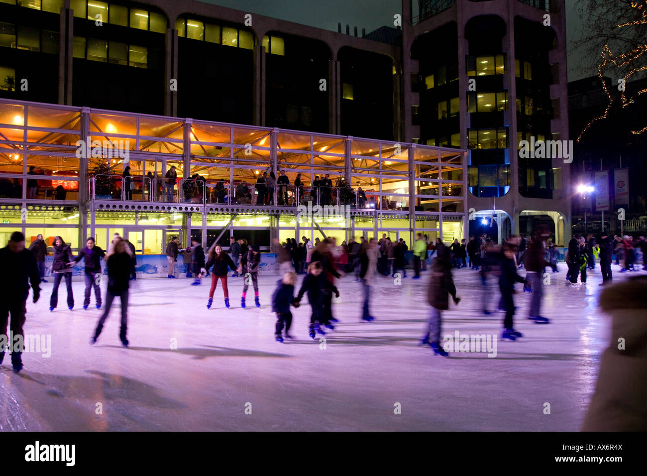 Tourists ice skating in rink National History Museum City Of London