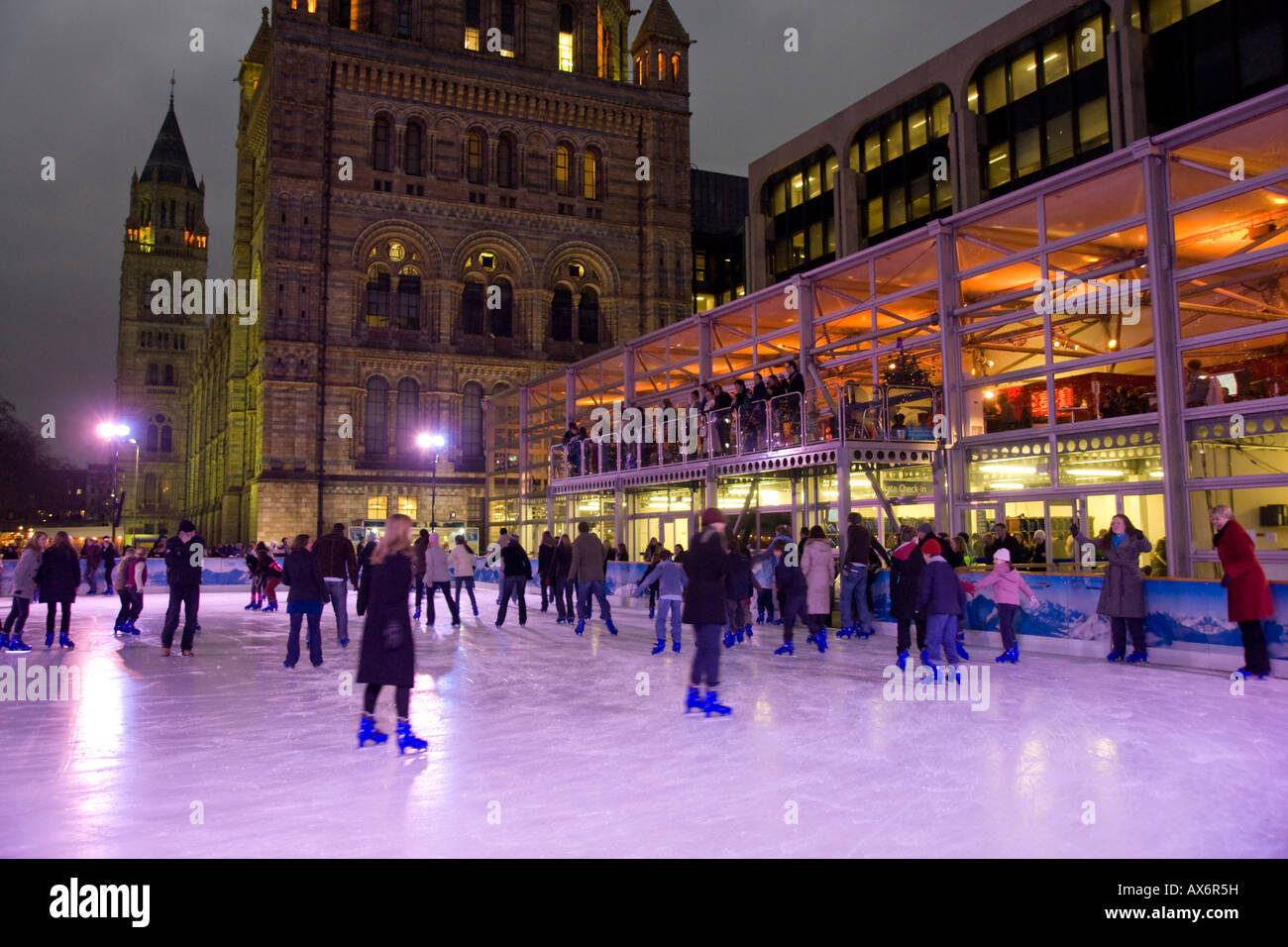 Tourists ice skating in rink National History Museum City Of London