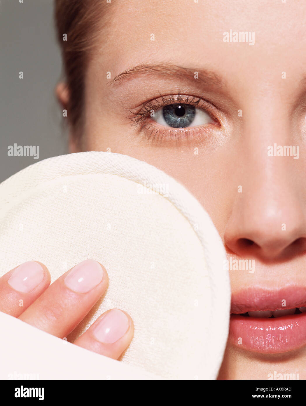 Woman using loofah pad on her face Stock Photo Alamy