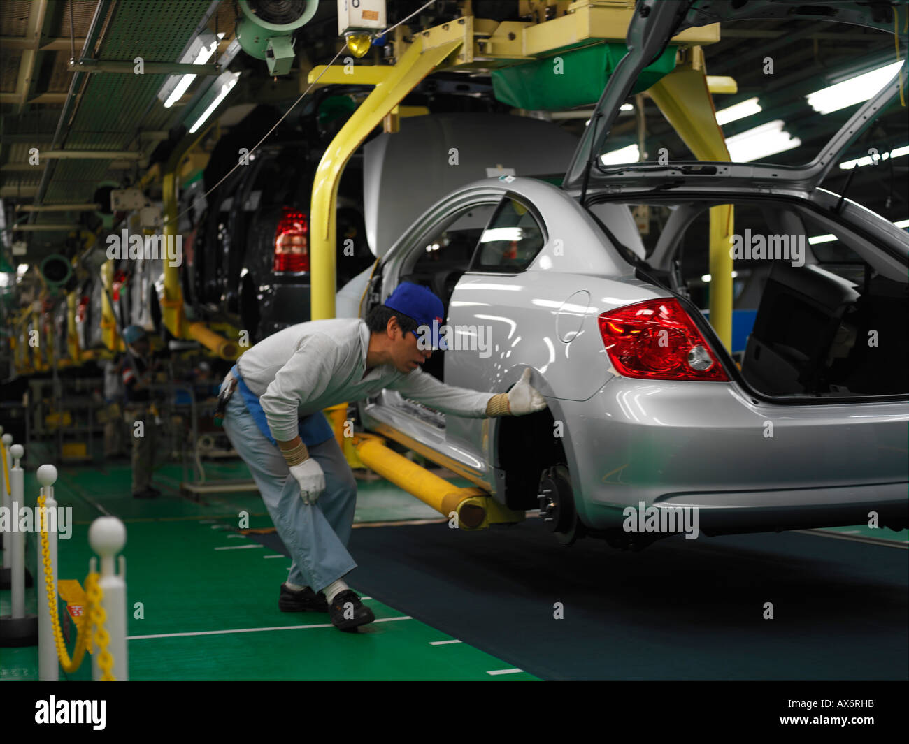 Factory workers producing the hybrid Toyota Prius cars work on the assembly line at the Toyota City Stock Photo
