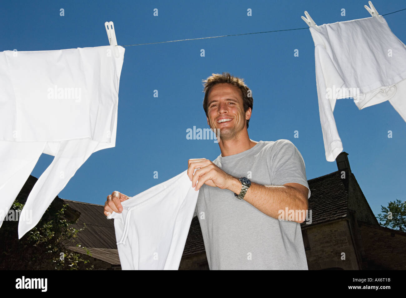 Man hanging out washing Stock Photo