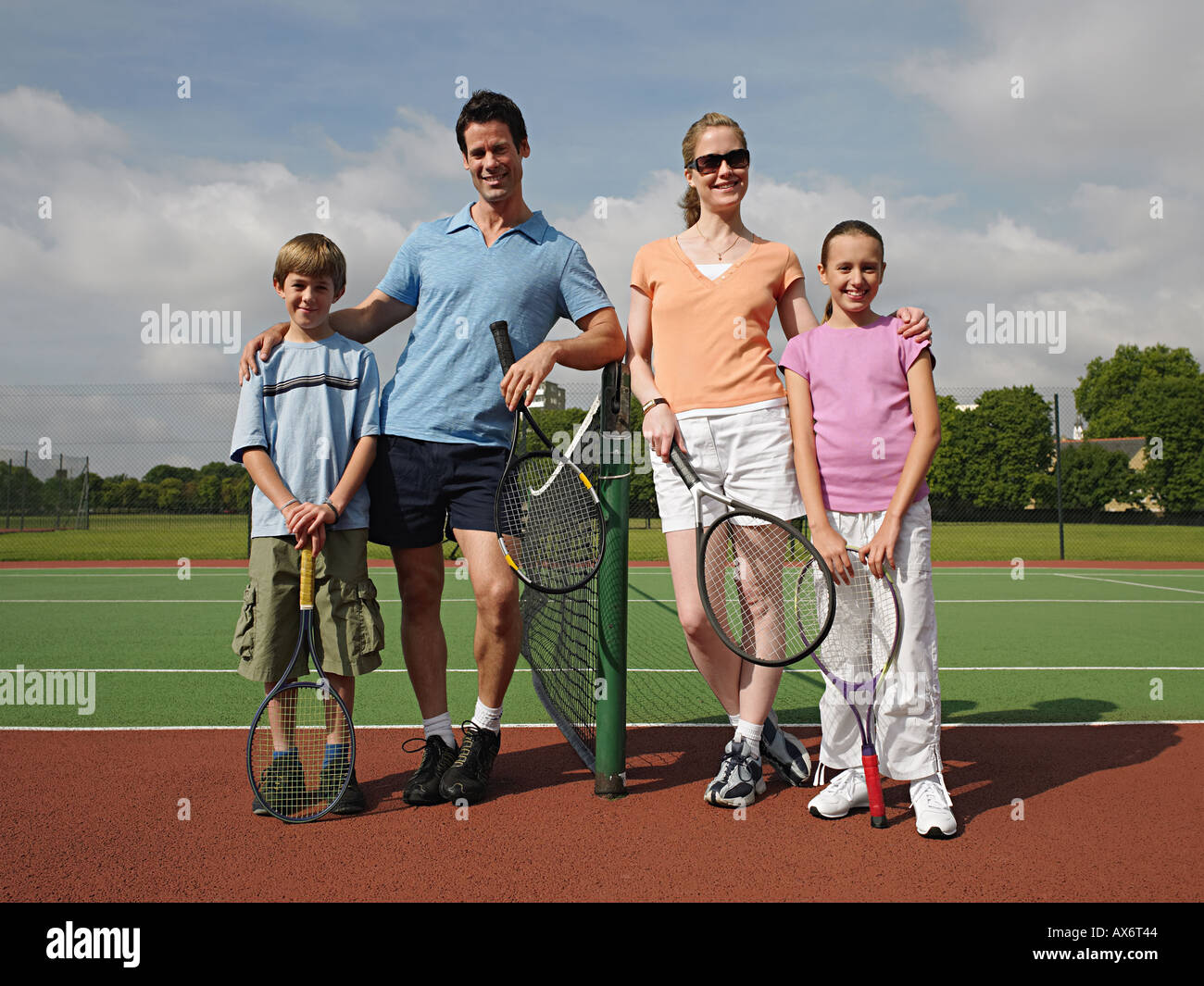 Family on a tennis court Stock Photo
