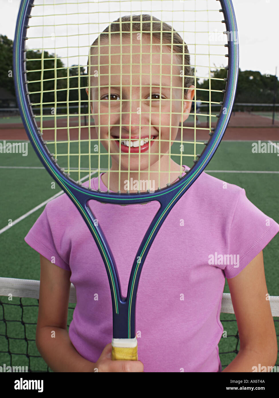 Girl holding up a tennis racket Stock Photo
