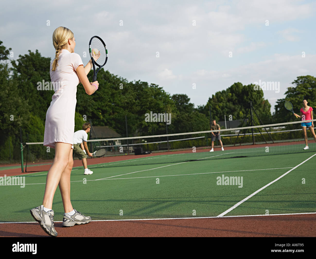 Young people playing tennis Stock Photo