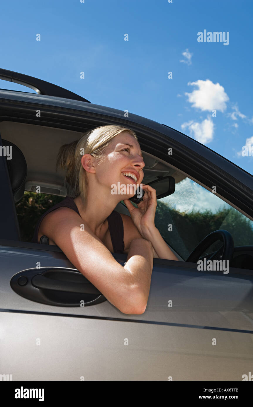 Woman in car using mobile phone Stock Photo