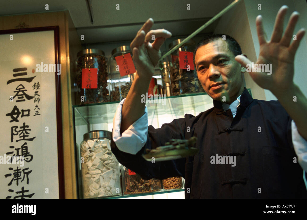 Chinese herbal medicines are weighed by a local herbal healer renowned in Hong Kong Stock Photo